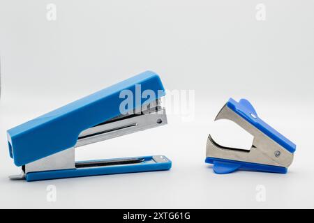 Blue stapler and stapler on white background facing each other, school, business concept Stock Photo