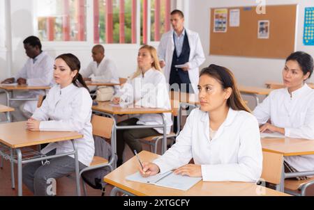 Medical students writing in notepads lesson Stock Photo