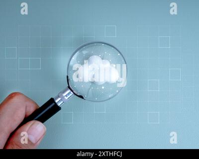 Cloud computing infrastructure technology, data system storage connection concept. Polygon graphic on white cloud in magnifying glass lens in business Stock Photo