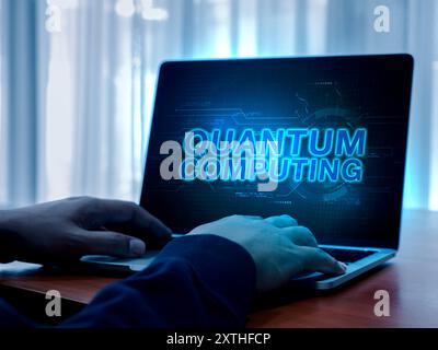 Quantum computing, future technology concept. Glowing text "Quantum Computing" with abstract hud interface graphic background on laptop computer displ Stock Photo