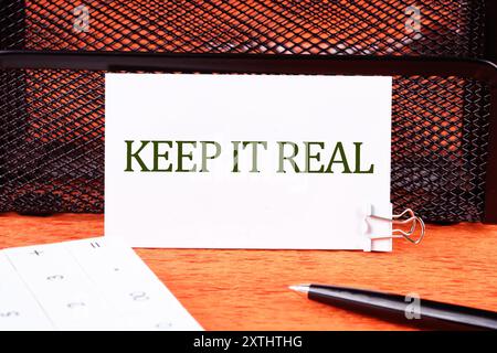 Conceptual symbol. Copy space. Keep it real words written on a white business card Stock Photo