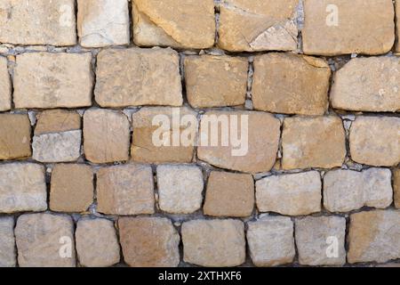 Background texture of warm coloured stone blocks in a wall Stock Photo