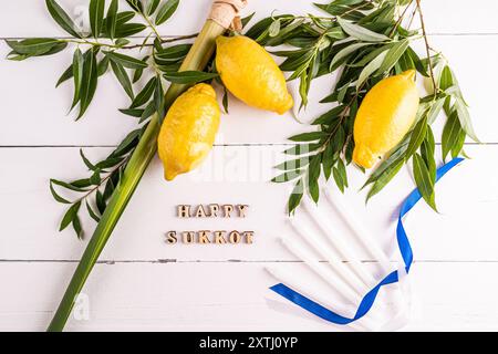 A beautiful festive background for the Jewish harvest festival of Sukkot with traditional symbols and candles. Wooden letters of the Sukkot. Stock Photo