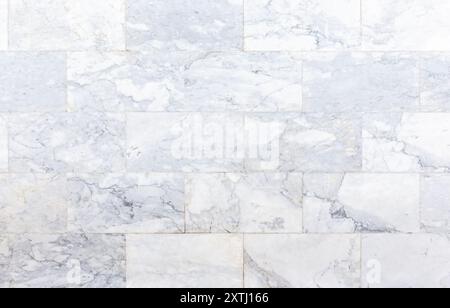 Worn smooth natural marble stone tiled flooring viewed from above. Abstract high resolution full frame textured background with copy space. Stock Photo