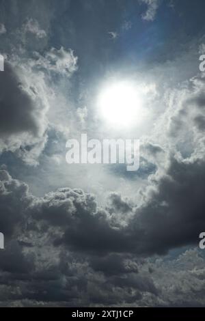 Heavenly summertime cloudscape dazzling sun stormy clouds Stock Photo