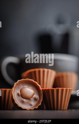 Sweet pralines. Chocolate truffles on a black table. Stock Photo