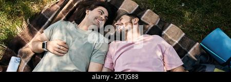 A young gay couple enjoys a sunny summer day while hiking in the wilderness. Stock Photo