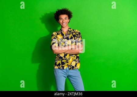 Photo of smiling positive guy crossing hands look isolated green bright color background Stock Photo