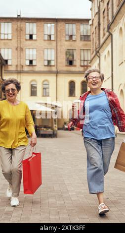 Joyful and happy seniors are enjoying a delightful day out together while shopping Stock Photo