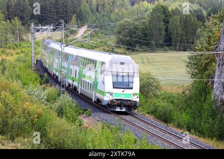 Modern VR Group Intercity electric 2 storey passenger train on the move after departing Salo on a day of summer. Salo, Finland. August 10, 2024. Stock Photo