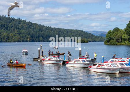 Small pleasure boats for tourists to hire on the waterfront in Bowness-on-Windermere in the Lake District National Park in England on a sunny day. Stock Photo