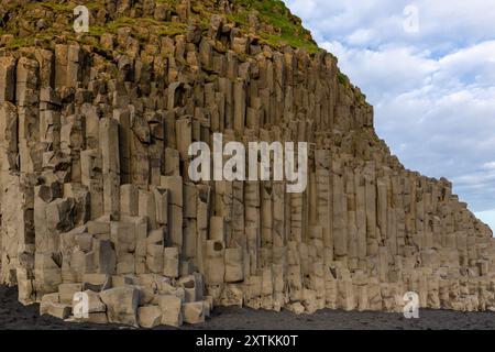 Basalt hexagonal columns rock formation on Reynisfjara Black sand beach, Iceland. Stock Photo