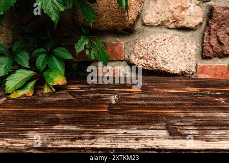 Empty wooden table against old brick wall Stock Photo