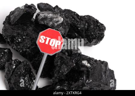 Pile of coal isolated on white background with stop sign. Concept of abandoning coal Stock Photo