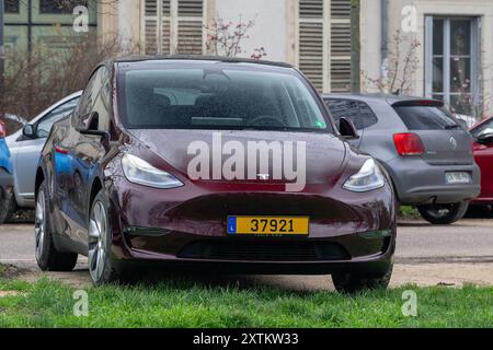 Nancy, France - View on a burgundy Tesla Model Y parked on a parking lot. Stock Photo