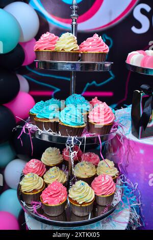 cupcake in different colors on a cupcake stand. Birthday food concept Stock Photo