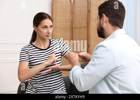 Man and woman using sign language for communication at home Stock Photo