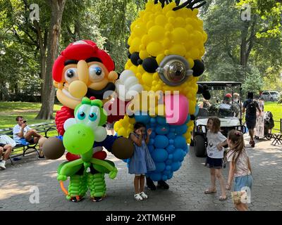 August 15, 2024, New York City, New York: (NEW) Balloon Story at Central Park. August 15, 2024, New York, USA: Balloon Story displaying characters like Mario, Yoshi and Mania at Central Park, on their way to the Balloon Story exhibition at Armory on 66 and Park; attracting curious people especially kids who got involved in a dance show with them.Credit: Niyi Fote/Thenews2 (Foto: Niyi Fote/Thenews2/Zumapress) (Credit Image: © Niyi Fote/TheNEWS2 via ZUMA Press Wire) EDITORIAL USAGE ONLY! Not for Commercial USAGE! Stock Photo