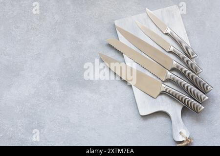 Casting steel various chef knife, Set of modern sharp kitchen knives on dark background Stock Photo