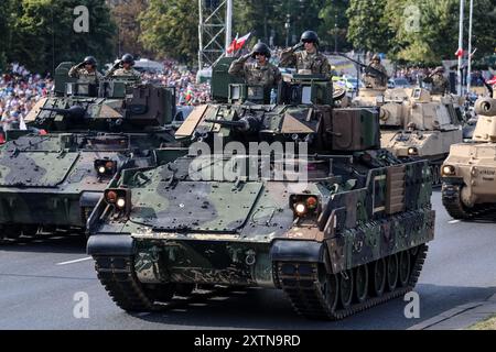 Warsaw, Poland. 15th Aug, 2024. Polish servicemen present M3 Bradley tracked armored reconnaissance vehicle on Wislostrada in the centre of Warsaw, the capital Poland during a military parade on Polish Army Day on August 15, 2024 on August 15, 2024. The parade presents over 200 military units of the Polish army. President of Poland Andrzej Duda, Prime Minister Donald Tusk and many other Polish politicians watch the parade. (Photo by Dominika Zarzycka/Sipa USA) Credit: Sipa USA/Alamy Live News Stock Photo