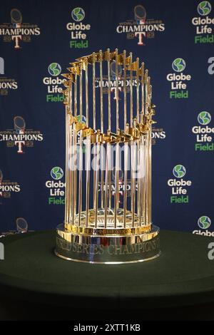 DALLAS, TX, USA - AUGUST 15, 2024. Attendees pose with the MLB Commisioner's Trophy at the August WESA Trade Show and Dallas Market. Stock Photo