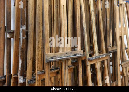 A roomfull of empty stacked used wooden painting easels from a fine art college, school or university. Stock Photo