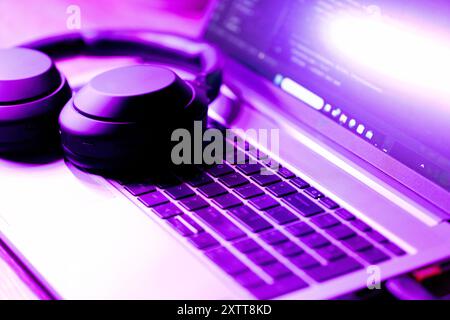 software development concept,  laptop with software code on screen in neon purple light, suitable for software development , IT education topics Stock Photo