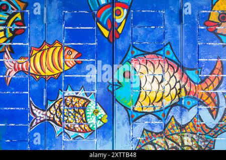 A fish mural seen on a door on Santa Maria Street in Funchal, Madeira on 9 August 2024.  This is one of dozens of pretty doors painted as part of the Stock Photo