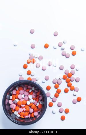 Colorful pills in black plastic box on white background. top view. Stock Photo