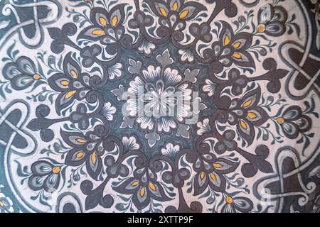 A patterned rug with a flower design Stock Photo