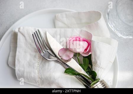Table setting with pink rose flowers Stock Photo