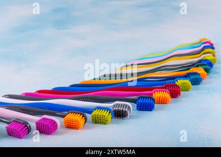 Several multi-colored toothbrushes close-up.  Different multi-colored toothbrushes stock images. Toothbrush on a blue background.  Medicine, dentistry Stock Photo