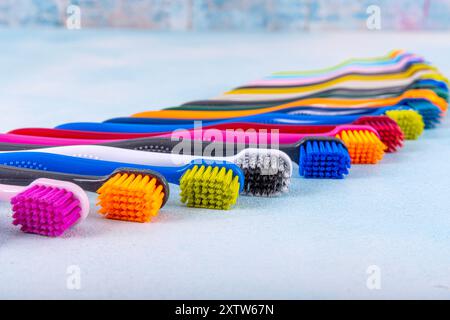 Several multi-colored toothbrushes close-up.  Different multi-colored toothbrushes stock images. Toothbrush on a blue background.  Medicine, dentistry Stock Photo