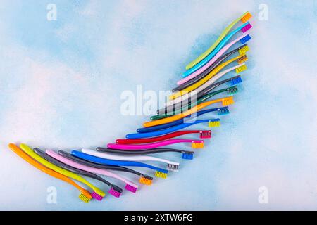 Several multi-colored toothbrushes close-up.  Different multi-colored toothbrushes stock images. Toothbrush on a blue background.  Medicine, dentistry Stock Photo