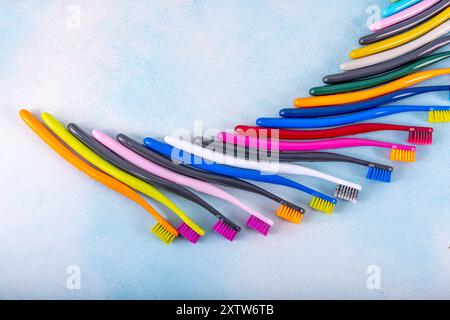 Several multi-colored toothbrushes close-up.  Different multi-colored toothbrushes stock images. Toothbrush on a blue background.  Medicine, dentistry Stock Photo