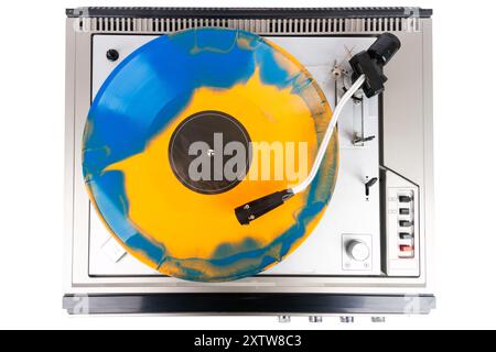 Vintage turntable record player with blue and orange vinyl isolated on white background. Stock Photo