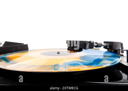 Close up of vintage turntable record player with blue and orange vinyl isolated on white background. Stock Photo