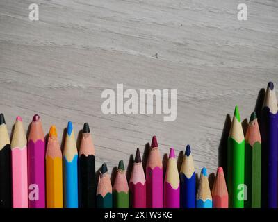 Photo of colored pencils on a wooden background for creative activities Stock Photo