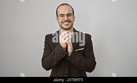 Bald bearded hispanic man in suit applauding against a white isolated background Stock Photo
