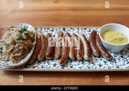 German cuisine: bratwurst (grilled pork sausages) and sauerkraut (sour cabbage) in Munich, Germany Stock Photo