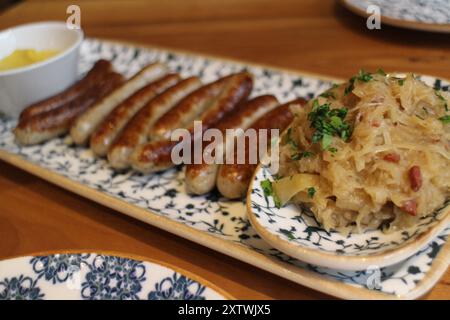 German cuisine: bratwurst (grilled pork sausages) and sauerkraut (sour cabbage) in Munich, Germany Stock Photo