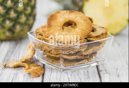 Pineapple rings (dried) on rustic wooden background as close-up shot Stock Photo