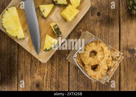 Pineapple rings (dried) on rustic wooden background as close-up shot Stock Photo