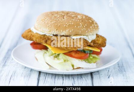 Fish Burger on wooden background (close-up shot, selective focus) Stock Photo