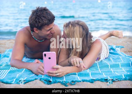 Young couple using smartphone app outdoors. Stock Photo