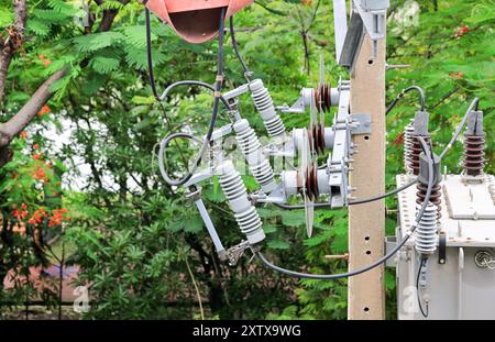 High Voltage Fuses on High voltage pole, off load switch Three-phase high-voltage fuses mounted on steel beams Wire connection on concrete pole. Stock Photo