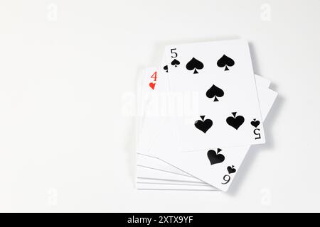 Flying playing card for poker and gambling, top with 5 spades - isolated on white background. Stock Photo