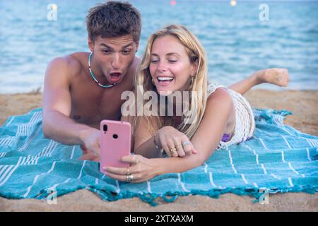 Young couple using smartphone app outdoors. Stock Photo