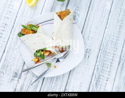 Chicken Wrap (detailed close-up shot, selective focus) on wooden background Stock Photo