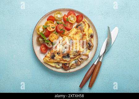 Omelette with mushrooms and cherry tomatoes for healthy breakfast from above Stock Photo